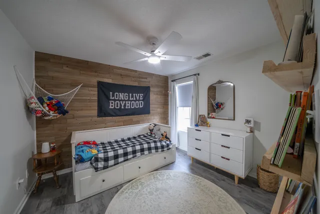 a bedroom with furniture and a book shelf