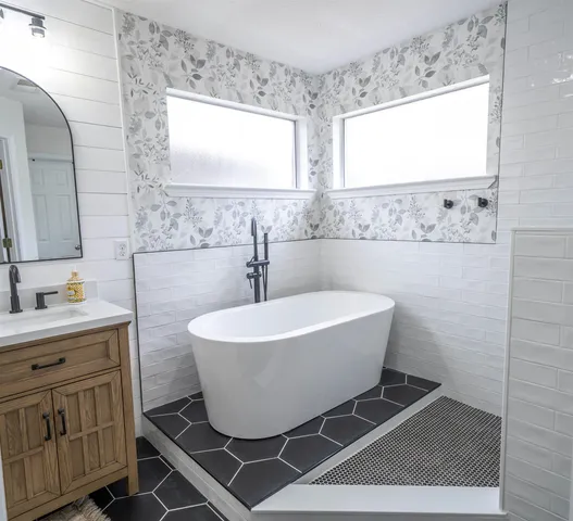 a white toilet sitting next to a bathroom sink