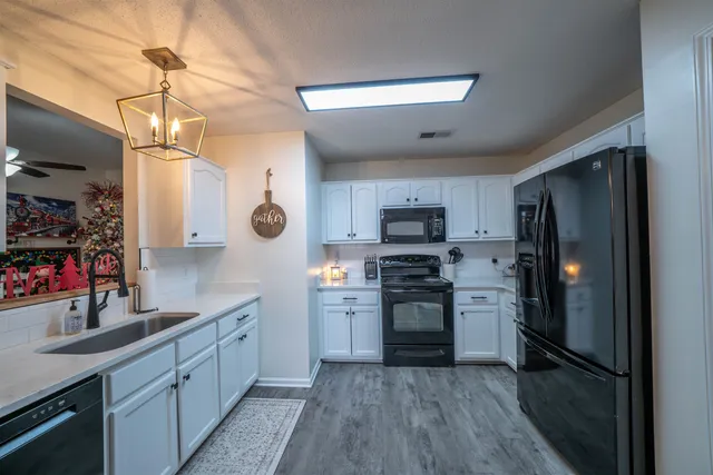a kitchen with a sink stove and microwave