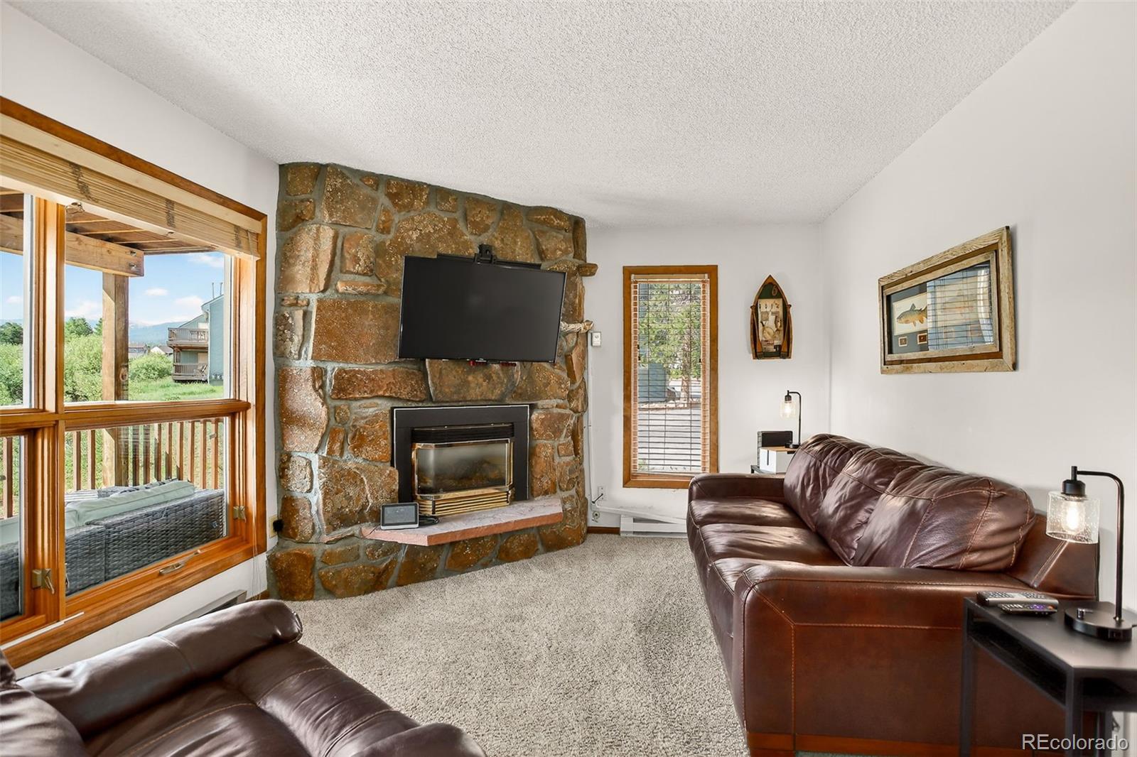 300 Sterling Way, Unit 2 Fraser, CO 80442 - Photo 13 of 28 a living room with furniture a flat screen tv and a fireplace
