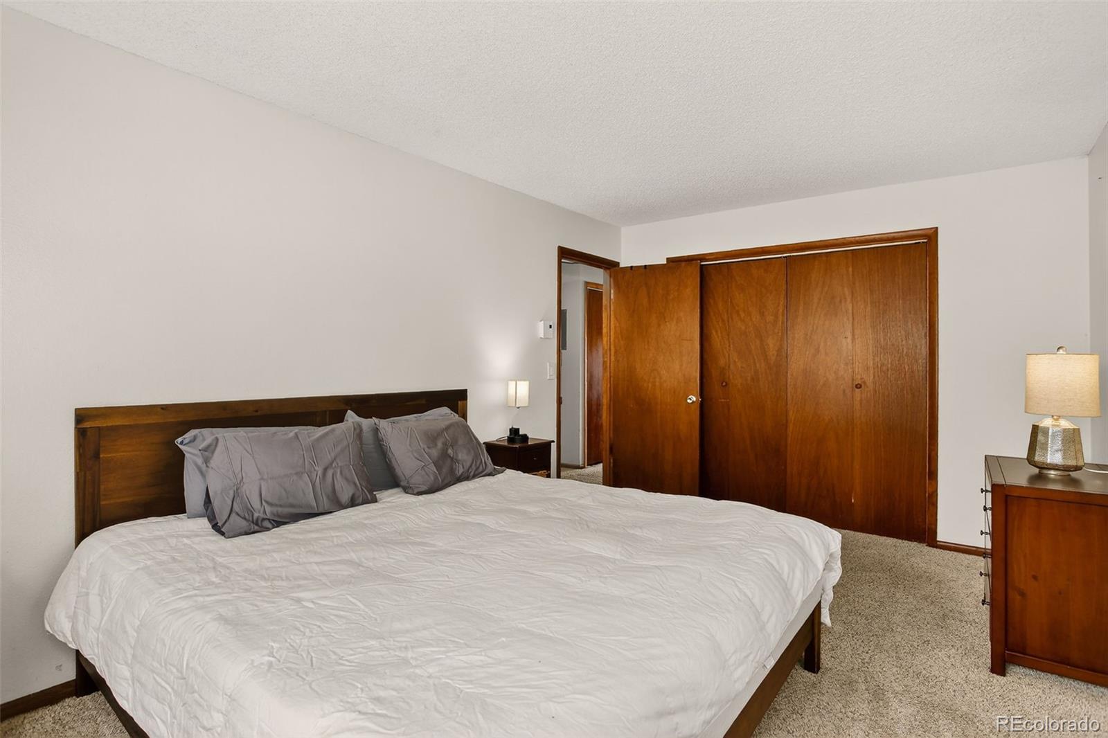 300 Sterling Way, Unit 2 Fraser, CO 80442 - Photo 17 of 28 a bedroom with a bed and a night stand