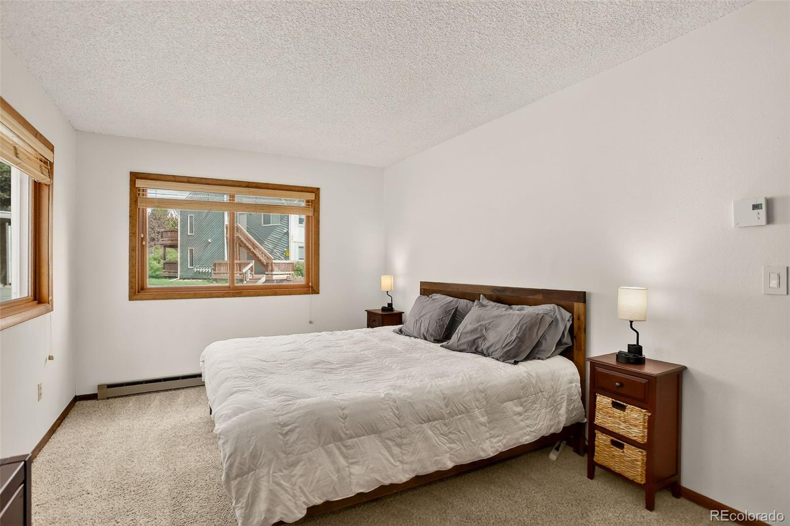 300 Sterling Way, Unit 2 Fraser, CO 80442 - Photo 18 of 28 a bedroom with a bed and painting on the wall