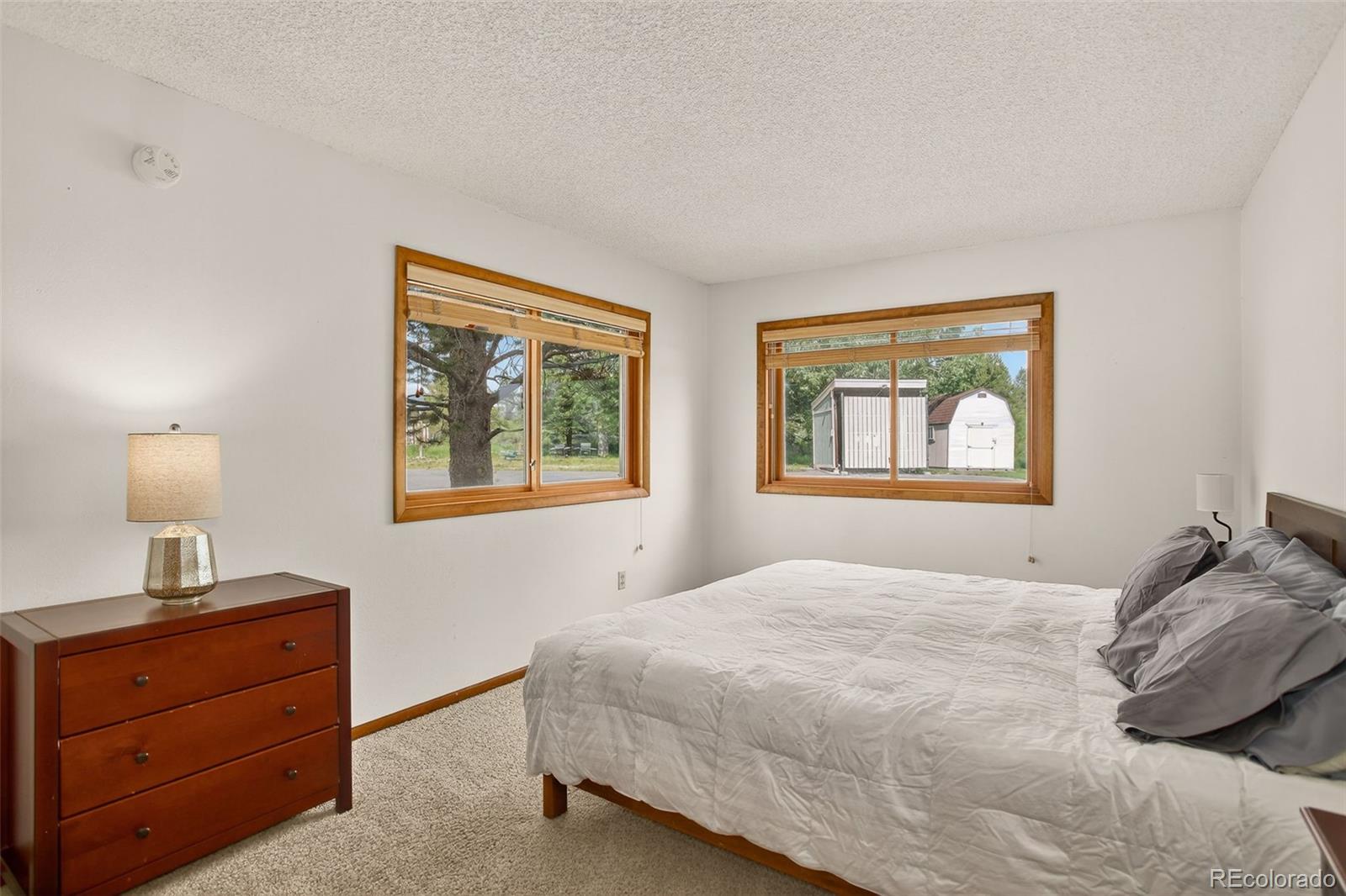 300 Sterling Way, Unit 2 Fraser, CO 80442 - Photo 20 of 28 a bedroom with a bed and a window