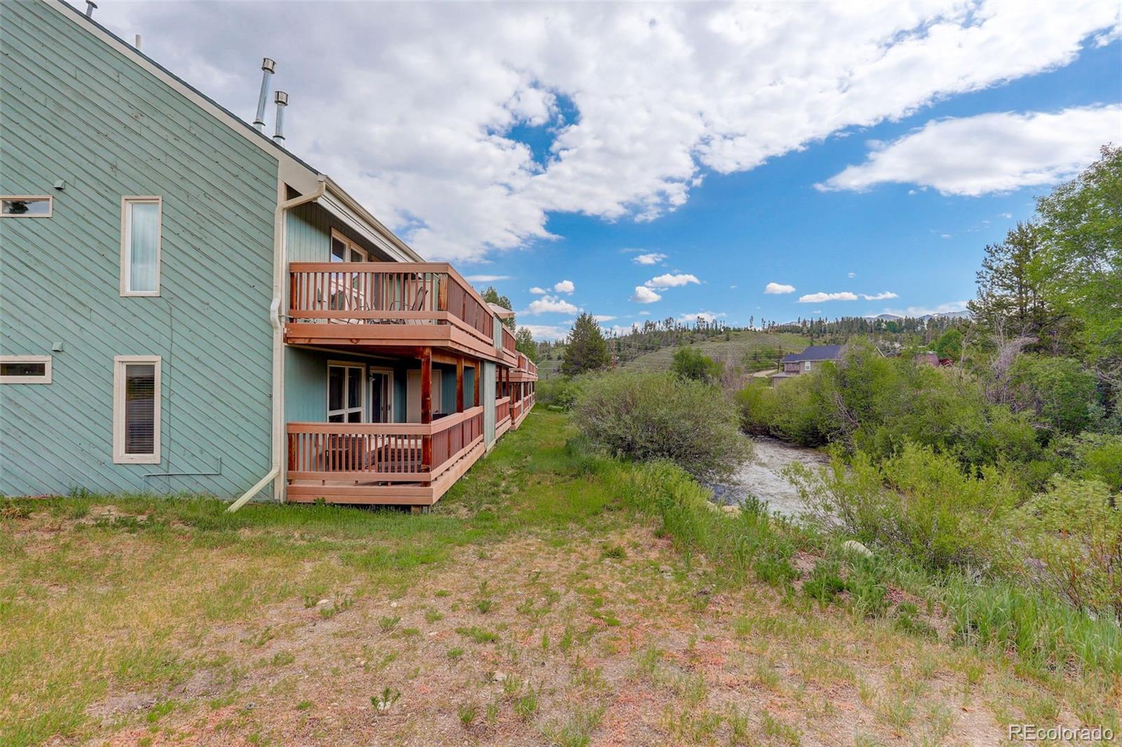 300 Sterling Way, Unit 2 Fraser, CO 80442 - Photo 24 of 28 a view of a house with a yard and deck