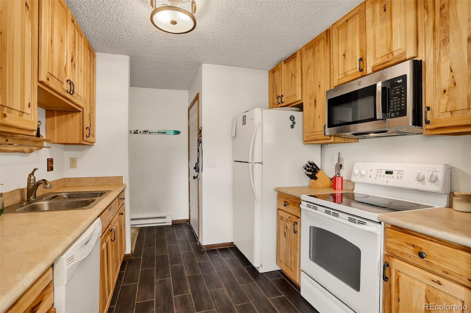 300 Sterling Way, Unit 2 Fraser, CO 80442 - Photo 8 of 28 a kitchen with stainless steel appliances a stove microwave and a refrigerator
