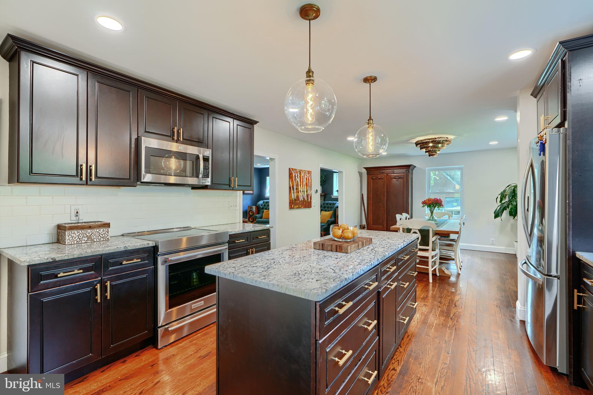 1310 Providence Road Baltimore, MD 21286 - Photo 11 of 31 a kitchen with granite countertop cabinets stainless steel appliances and wooden floor