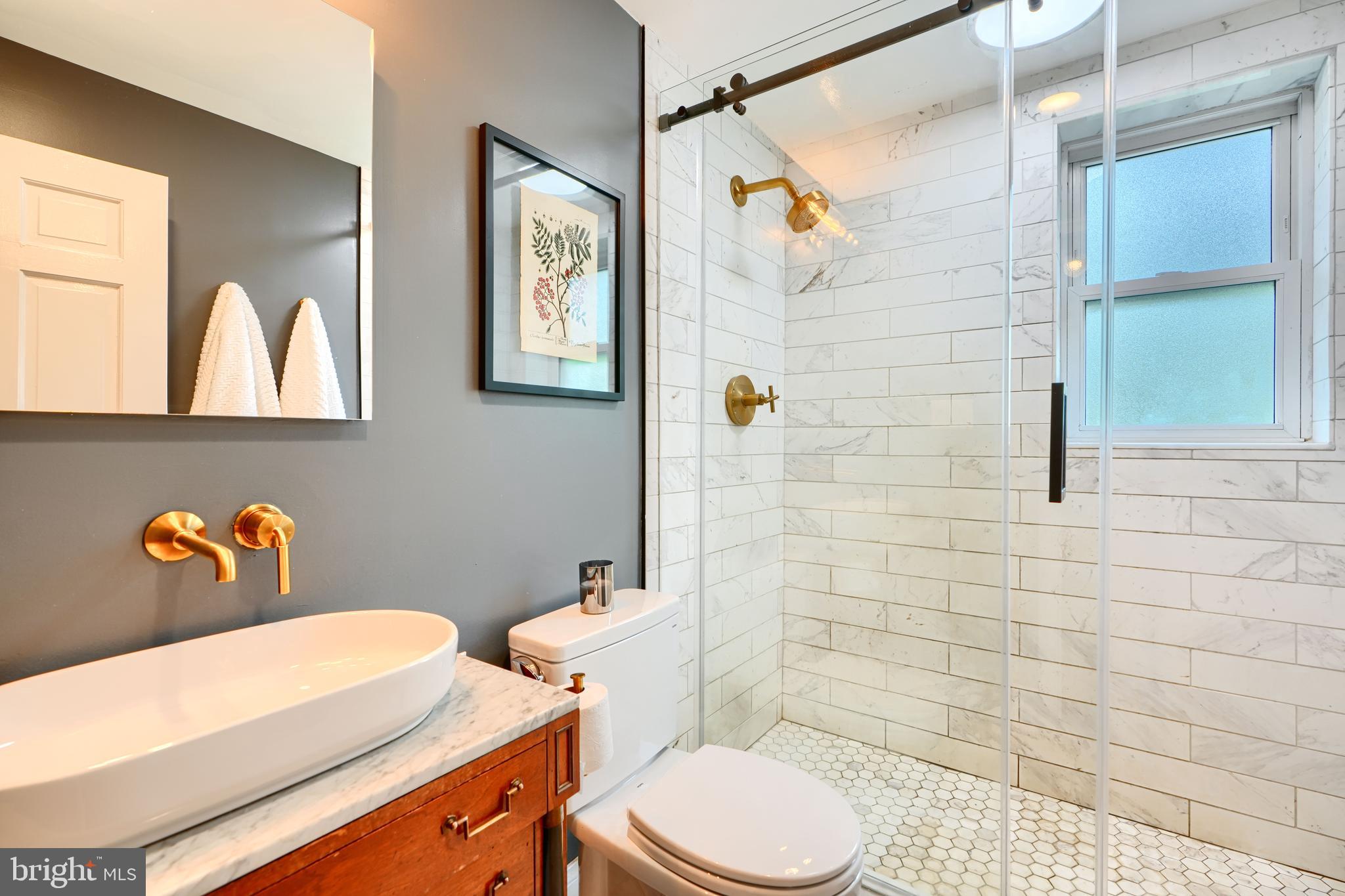 1310 Providence Road Baltimore, MD 21286 - Photo 22 of 31 a bathroom with a toilet sink vanity and mirror