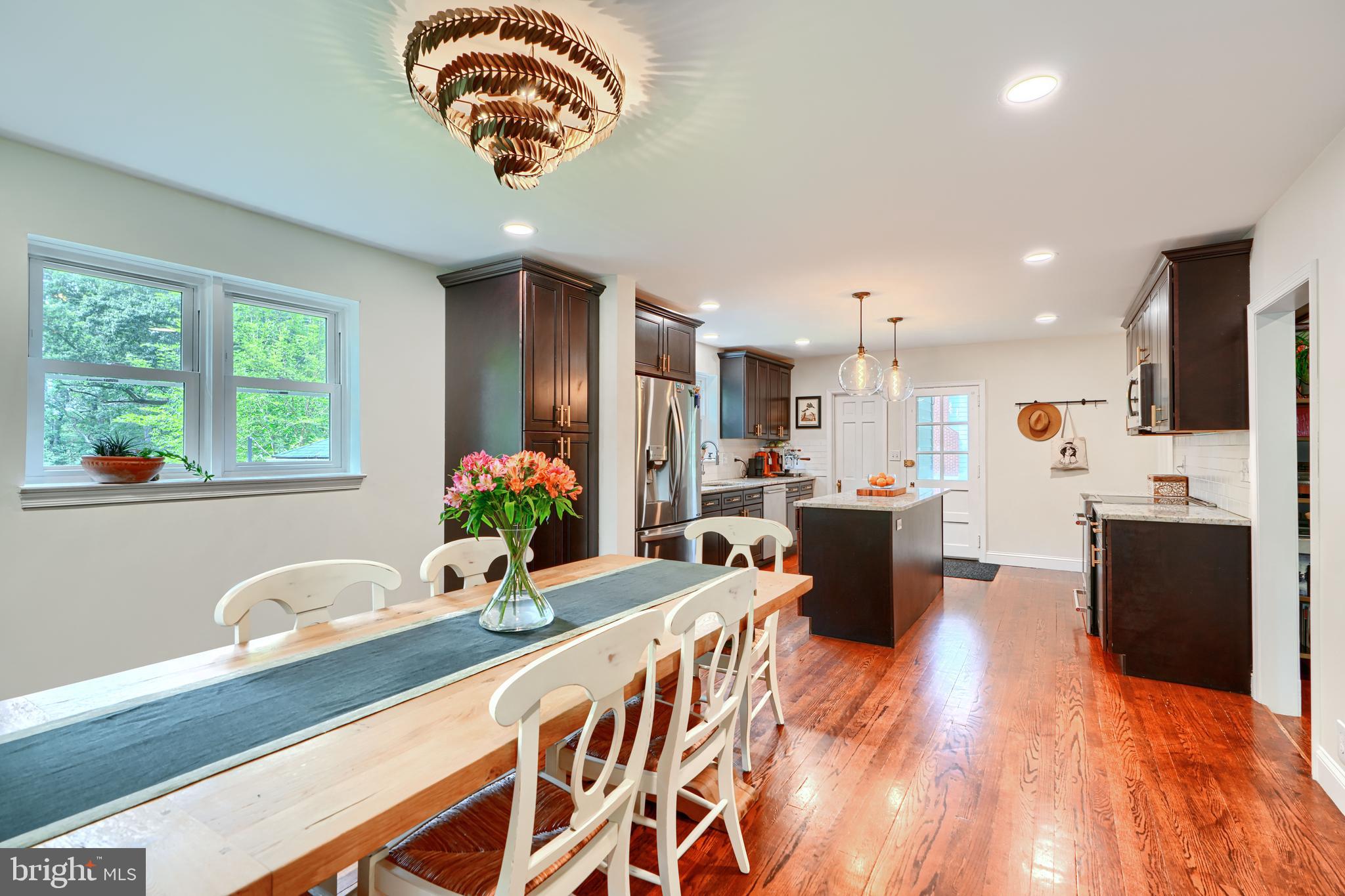 1310 Providence Road Baltimore, MD 21286 - Photo 7 of 31 a view of a kitchen with kitchen island stainless steel appliances wooden floor dining table and chairs