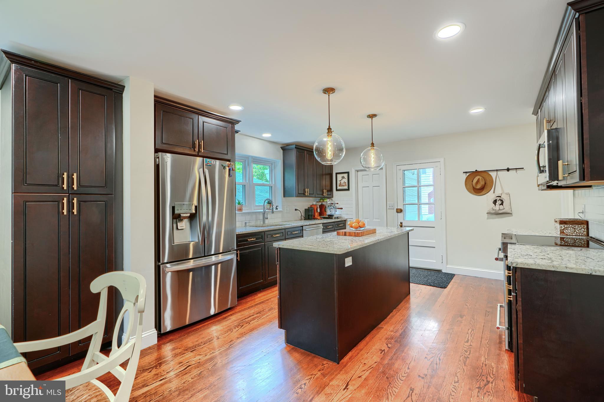 1310 Providence Road Baltimore, MD 21286 - Photo 8 of 31 a kitchen with stainless steel appliances granite countertop a refrigerator a stove top oven a sink dishwasher and wooden floor