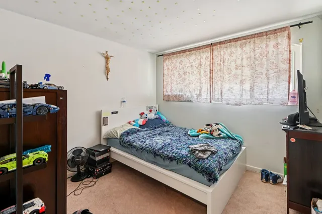 a bed room with a bed and a window