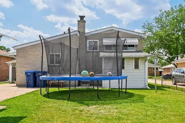 a wooden bench sitting in front of a house
