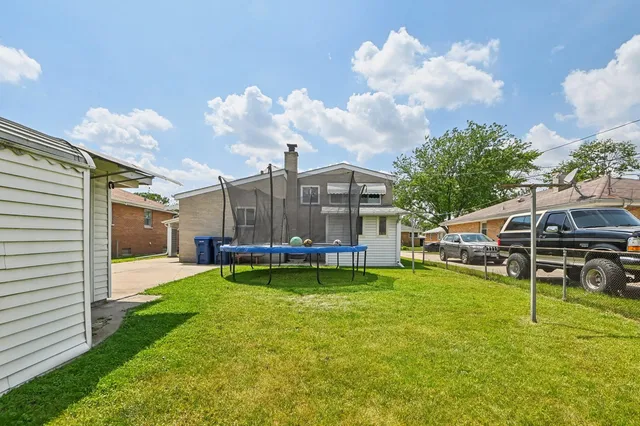 a view of a house with a backyard porch and sitting area