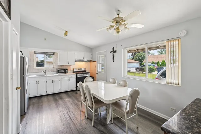 a view of a dining room with furniture and wooden floor