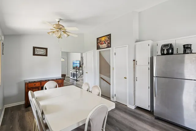 a view of kitchen with refrigerator and wooden floor