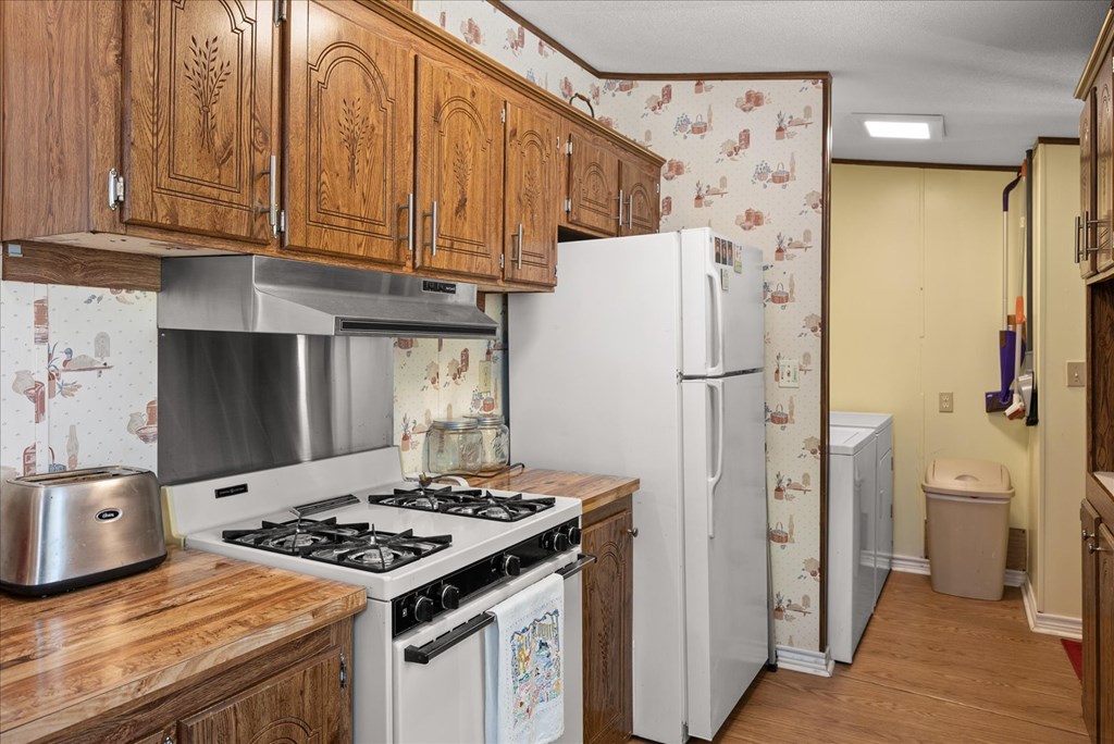 363 Elm Pass 2 Center Point, TX 78010 - Photo 19 of 60 a kitchen with stainless steel appliances granite countertop a refrigerator stove and a sink