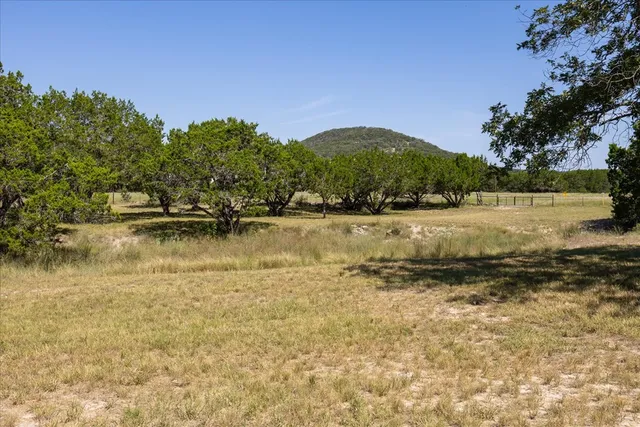 a backyard of a house with a yard and mountain view in back