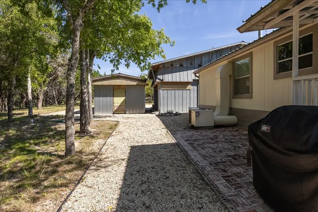 a view of a house with wooden fence