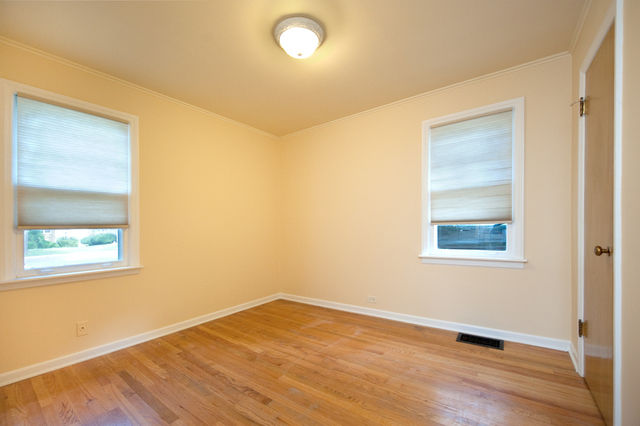 231 East Harrison Road Lombard, IL 60148 - Photo 14 of 16 an empty room with wooden floor and windows