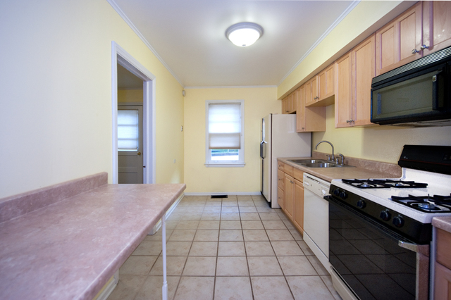 231 East Harrison Road Lombard, IL 60148 - Photo 4 of 16 a kitchen with stainless steel appliances a stove microwave and sink