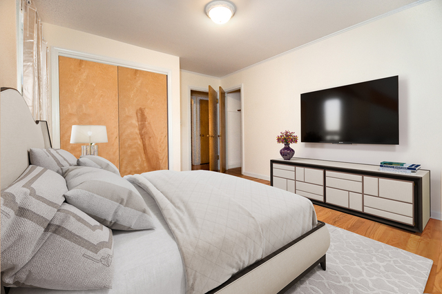 231 East Harrison Road Lombard, IL 60148 - Photo 8 of 16 a bedroom with a bed and a flat screen tv