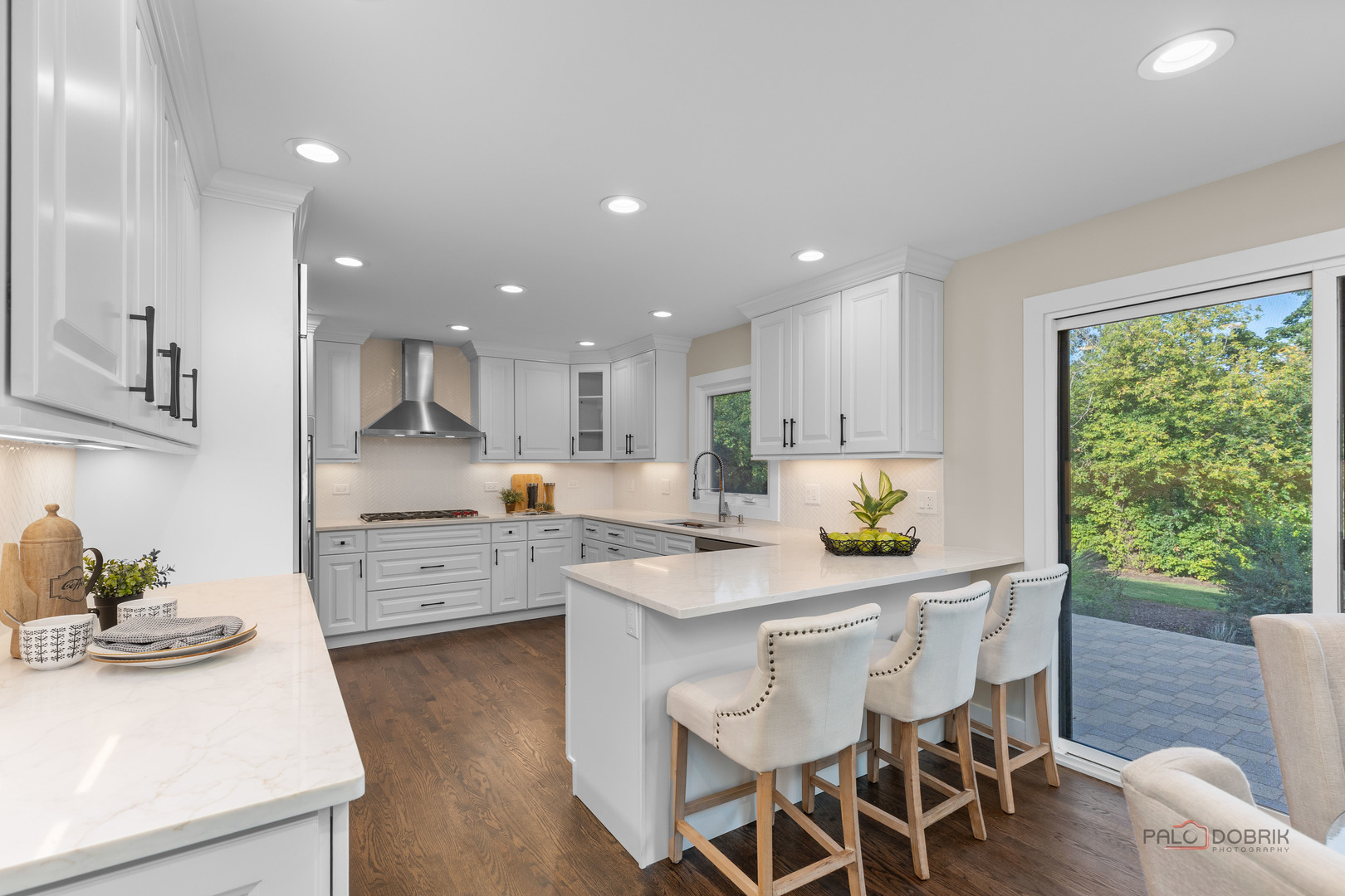 1075 Heather Road Deerfield, IL 60015 - Photo 13 of 45 a kitchen with stainless steel appliances kitchen island granite countertop a stove a refrigerator a sink a dining table and chairs