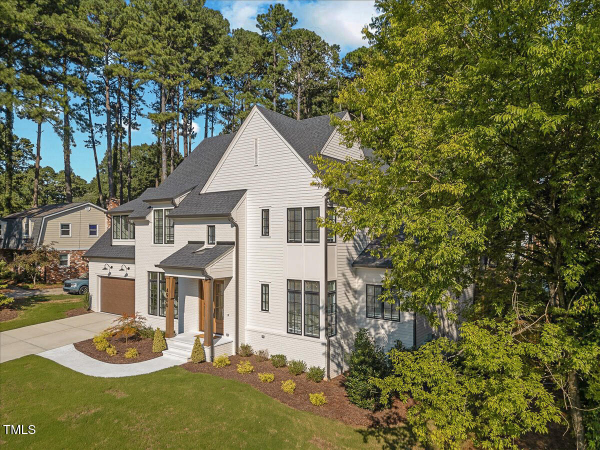 4906 Tremont Drive Raleigh, NC 27609 - Photo 2 of 78 a view of a white house with a small yard and plants