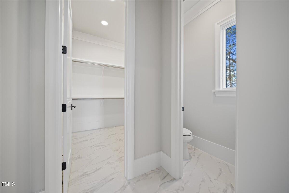 4906 Tremont Drive Raleigh, NC 27609 - Photo 31 of 78 a bathroom with a glass shower door