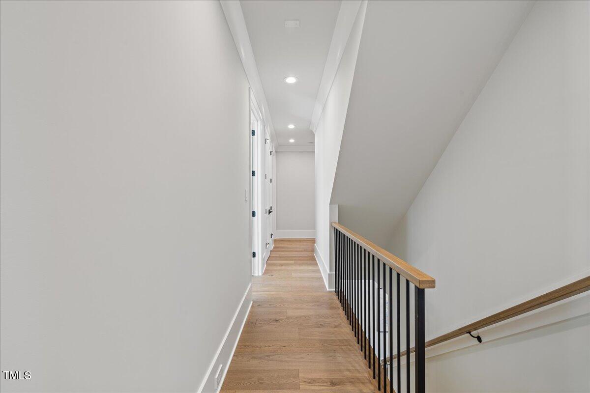 4906 Tremont Drive Raleigh, NC 27609 - Photo 42 of 78 a view of a hallway with wooden floor