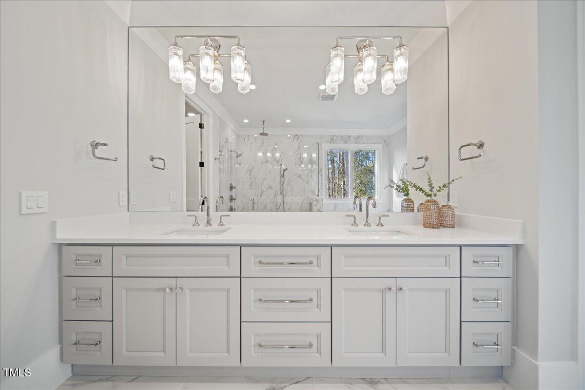 4906 Tremont Drive Raleigh, NC 27609 - Photo 46 of 78 a bathroom with a sink vanity and a mirror