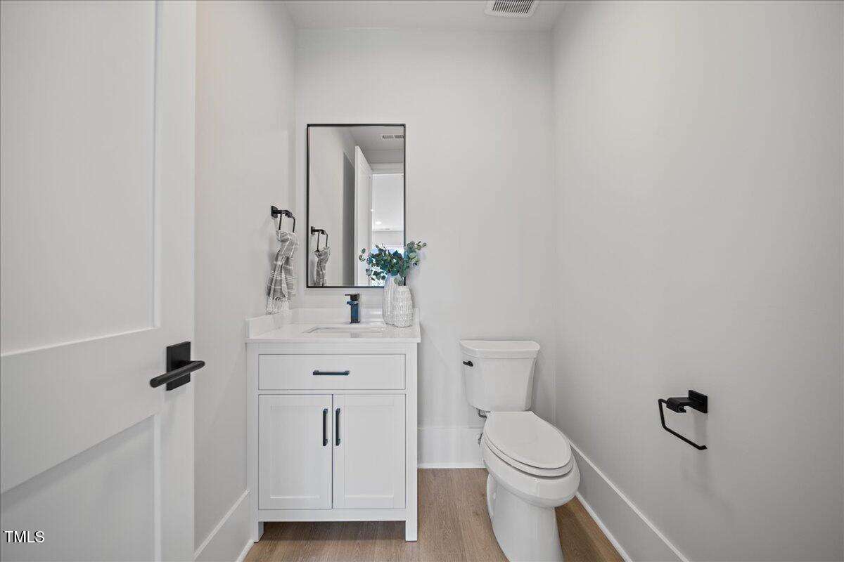4906 Tremont Drive Raleigh, NC 27609 - Photo 67 of 78 a bathroom with a toilet sink and mirror