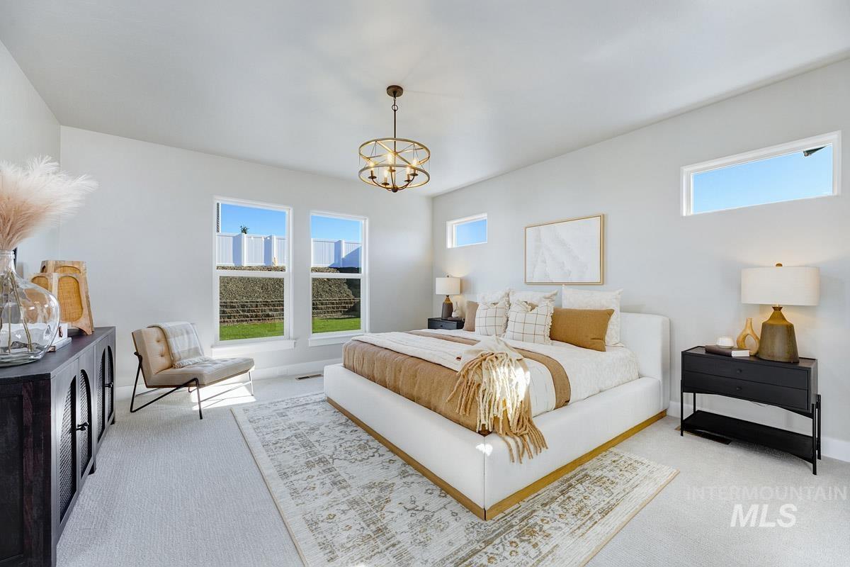 6792 Saddle Bred Way Star, ID 83669 - Photo 11 of 33 Bedroom featuring carpet, multiple windows, and a chandelier