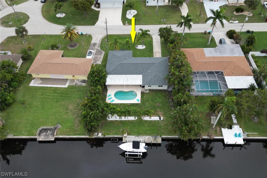 an aerial view of a house with a yard pool seating area and yard