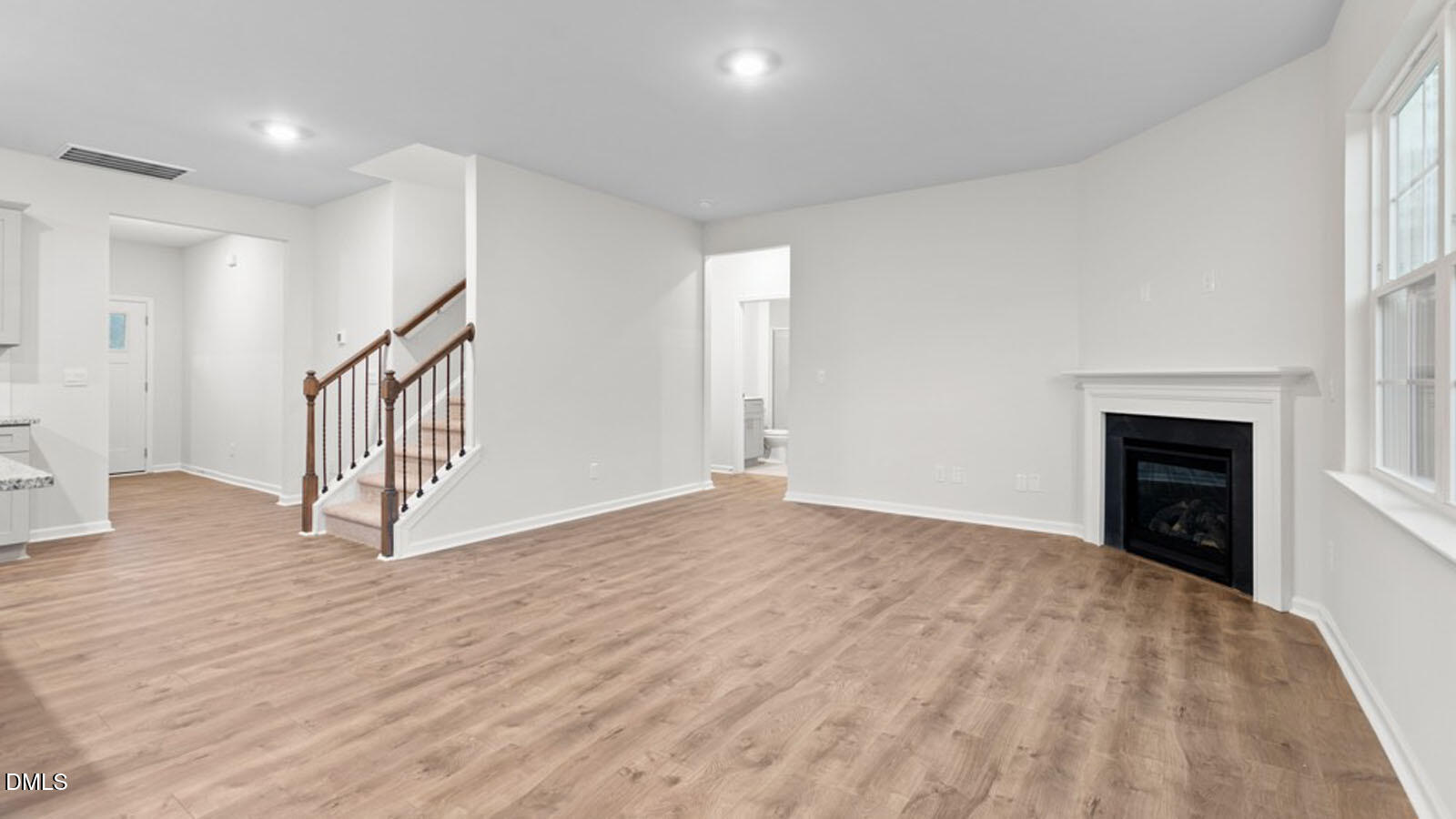 4027 Apollo Lane Snow Camp, NC 27349 - Photo 10 of 32 a view of an empty room with wooden floor fireplace and a window