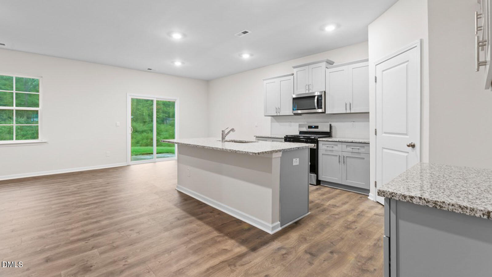 4027 Apollo Lane Snow Camp, NC 27349 - Photo 5 of 32 a kitchen with stainless steel appliances granite countertop a stove top oven a sink and a refrigerator