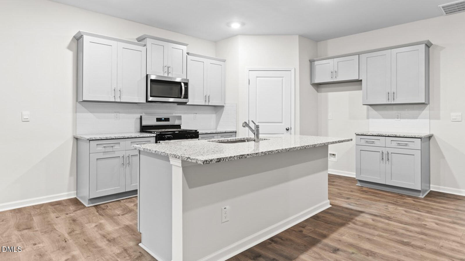 4027 Apollo Lane Snow Camp, NC 27349 - Photo 6 of 32 a kitchen with white cabinets sink and stainless steel appliances