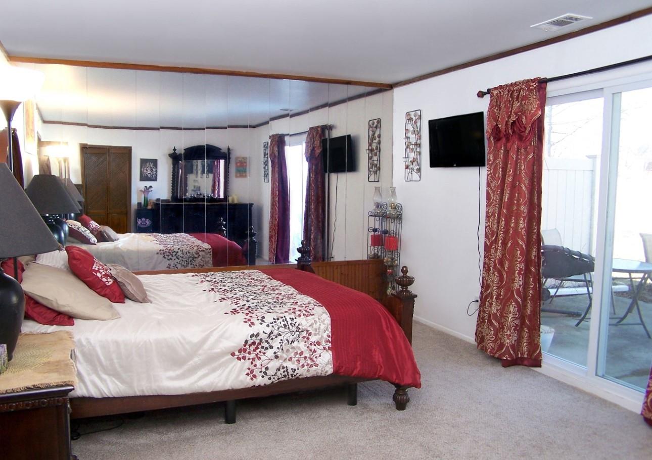 51 Rocky Point Yaphank Road, Unit 5 Rocky Point, NY 11778 - Photo 11 of 17 Bedroom featuring multiple windows, carpet floors, crown molding, and baseboards