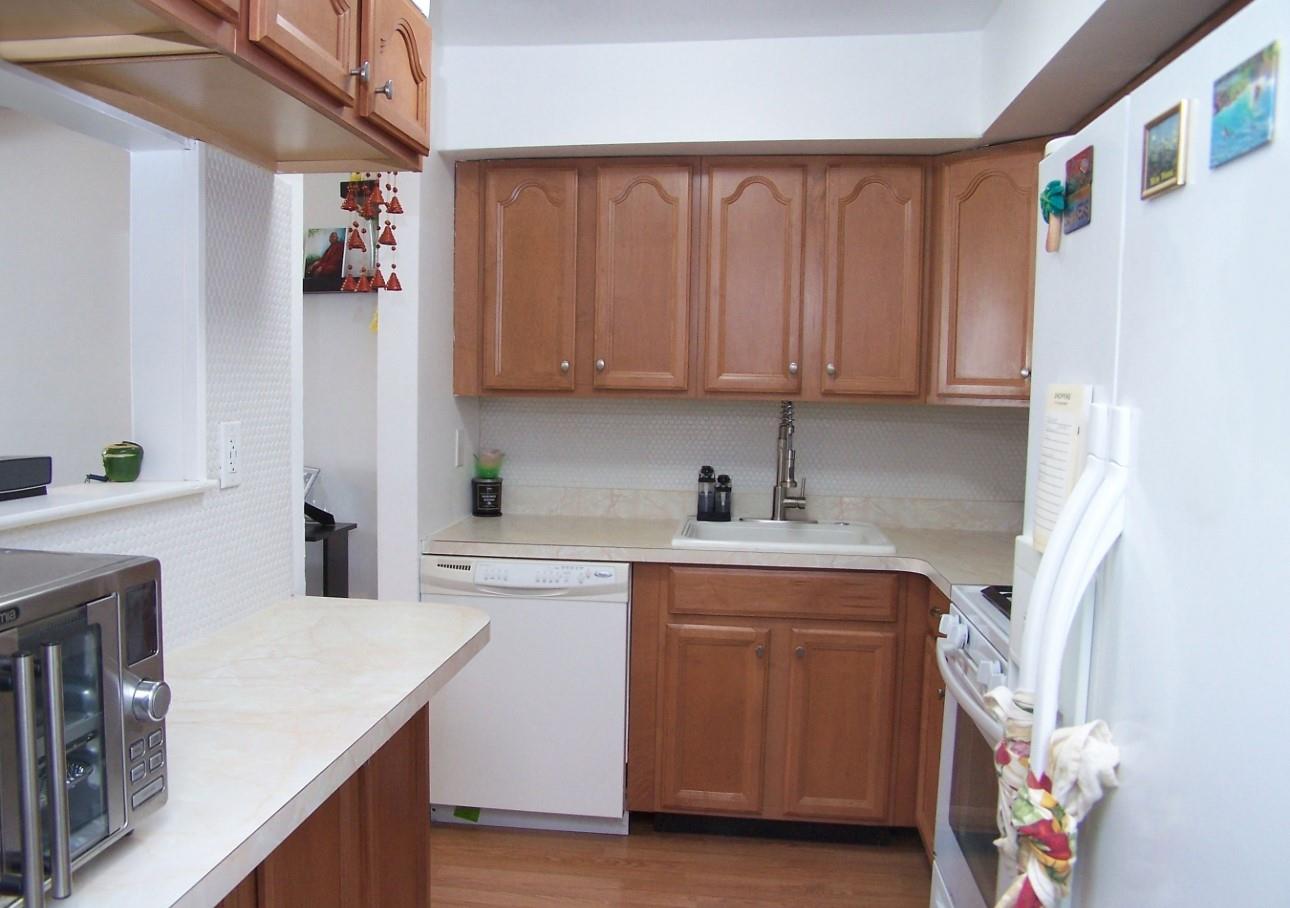 51 Rocky Point Yaphank Road, Unit 5 Rocky Point, NY 11778 - Photo 17 of 17 Kitchen with white appliances, light countertops, a sink, and decorative backsplash