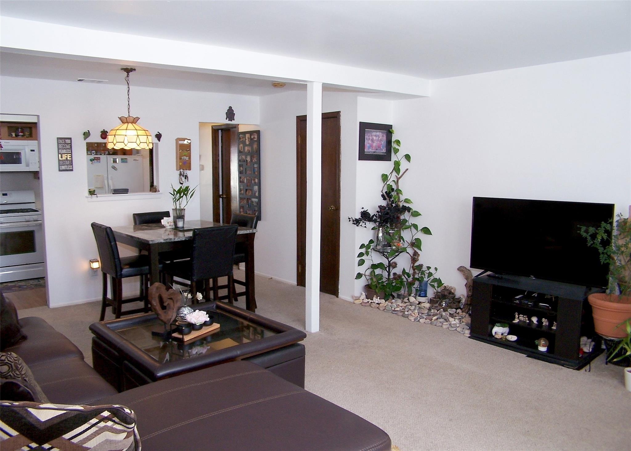 51 Rocky Point Yaphank Road, Unit 5 Rocky Point, NY 11778 - Photo 5 of 17 Living room featuring carpet floors