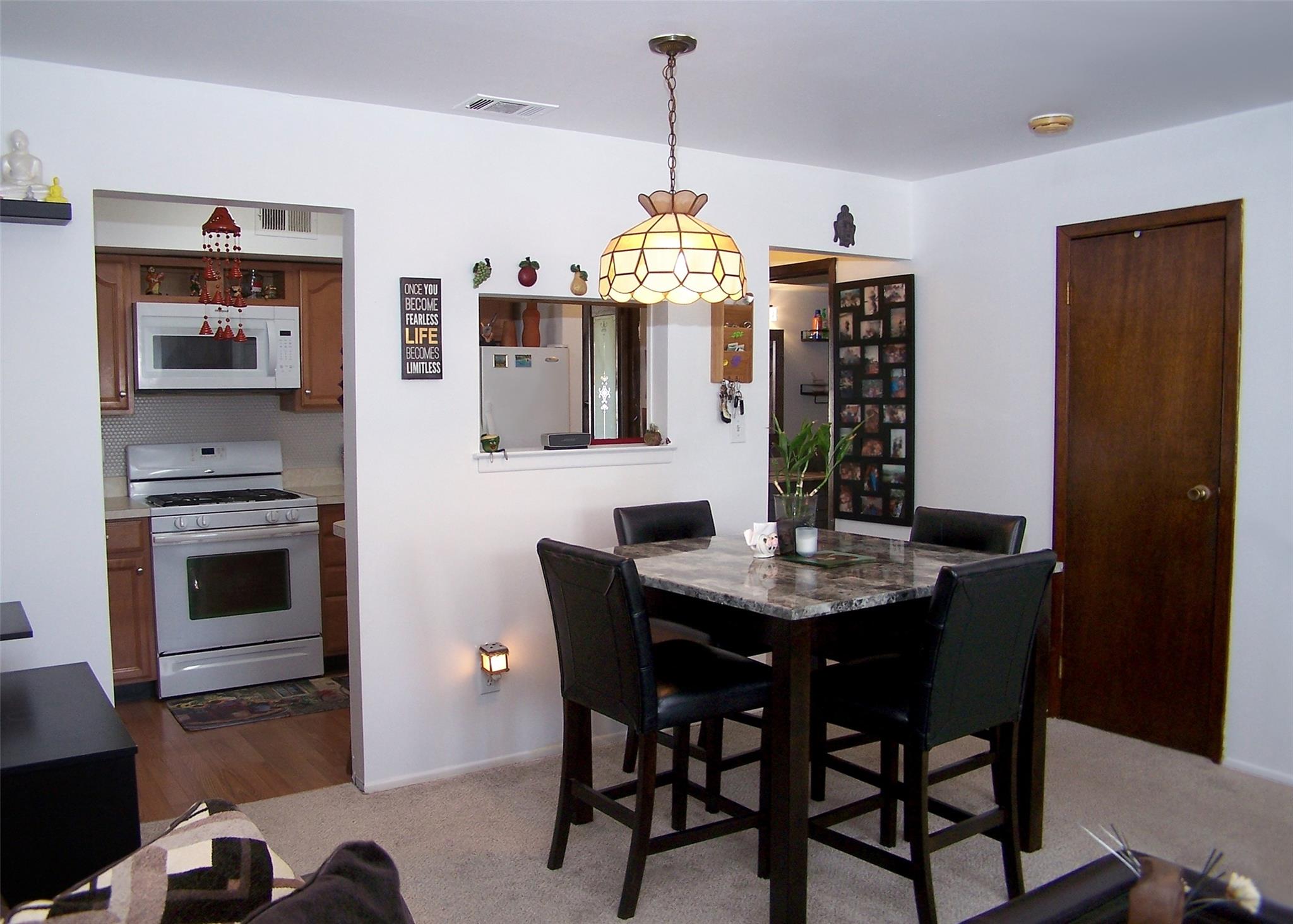 51 Rocky Point Yaphank Road, Unit 5 Rocky Point, NY 11778 - Photo 6 of 17 Dining space with carpet and baseboards