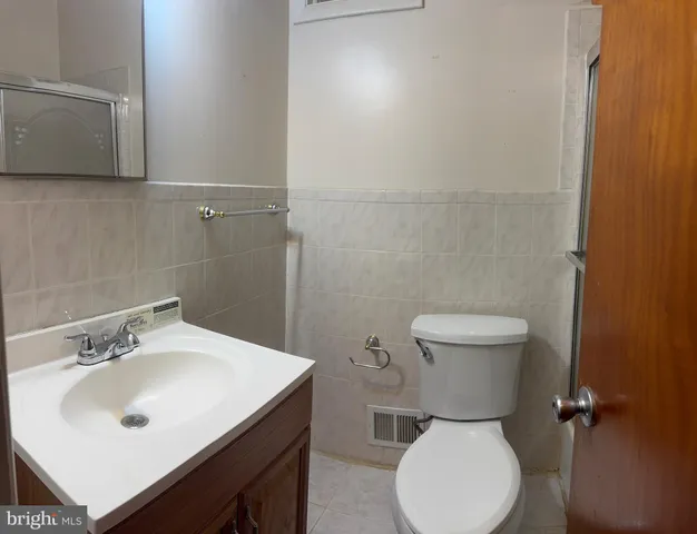 a white toilet sitting next to a bathroom sink