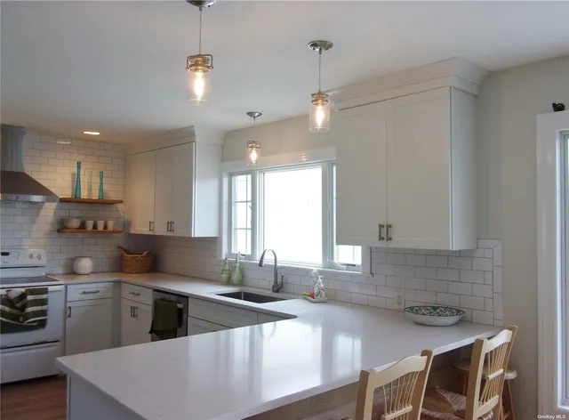 a kitchen with a stove a sink and a refrigerator