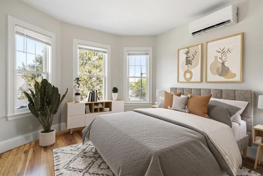 511 Geneva Avenue, Unit 2 Boston, MA 02122 - Photo 13 of 16 a spacious bedroom with a large bed and a potted plant
