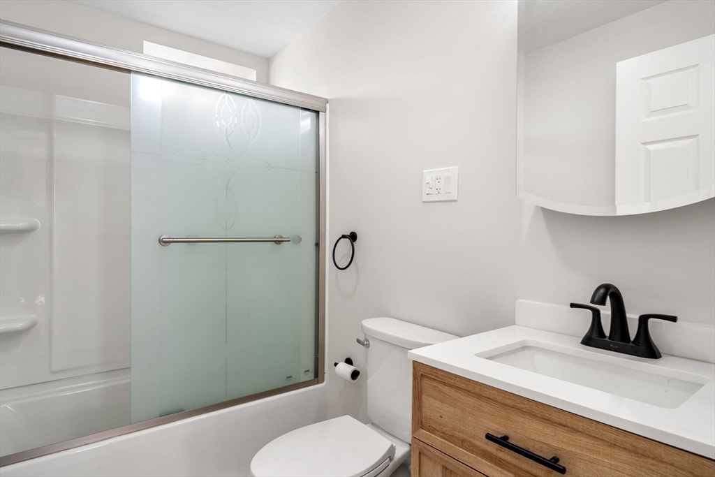 511 Geneva Avenue, Unit 2 Boston, MA 02122 - Photo 15 of 16 a bathroom with a sink a toilet and shower