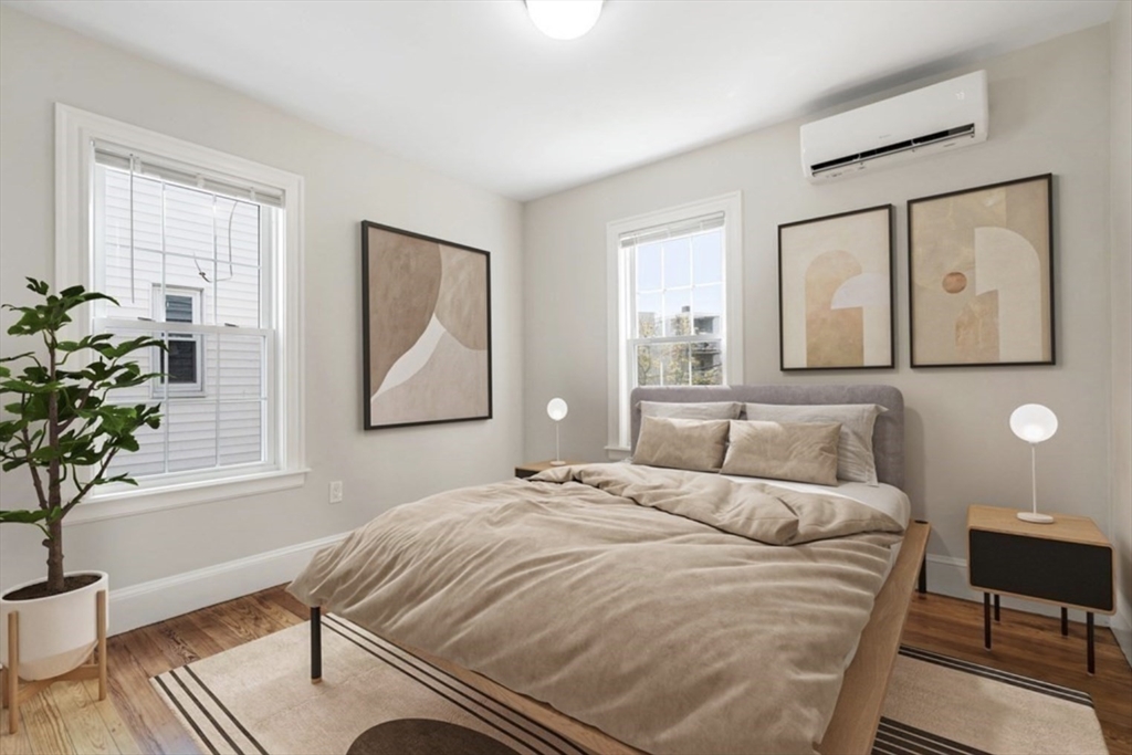 511 Geneva Avenue, Unit 2 Boston, MA 02122 - Photo 3 of 16 a bedroom with a bed and a potted plant