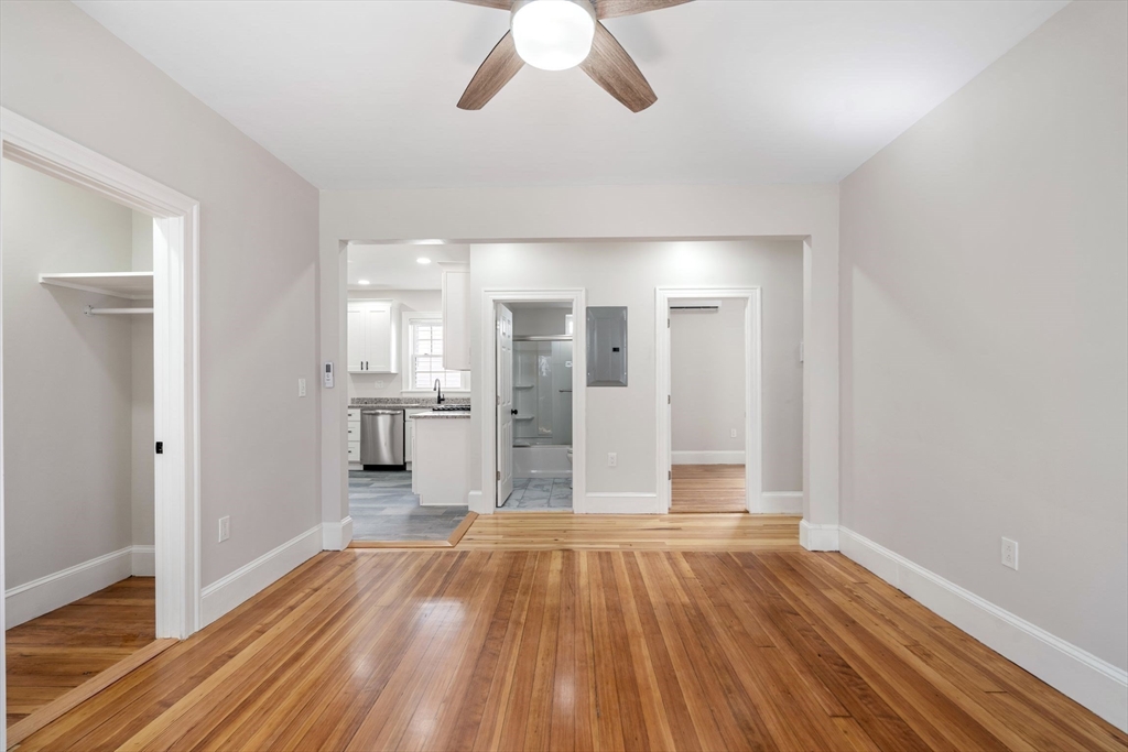 511 Geneva Avenue, Unit 2 Boston, MA 02122 - Photo 10 of 16 a view of a big room with wooden floor and a kitchen