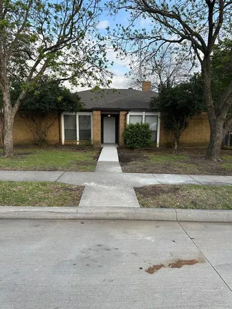 a front view of a house with a yard and a garage