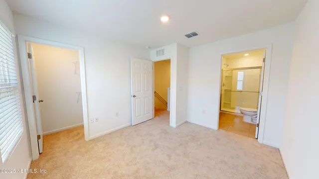 an empty room with a bathroom and a sink