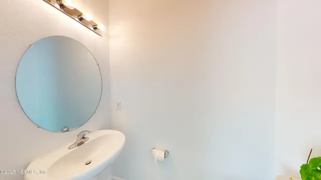 a bathroom with a sink and mirror