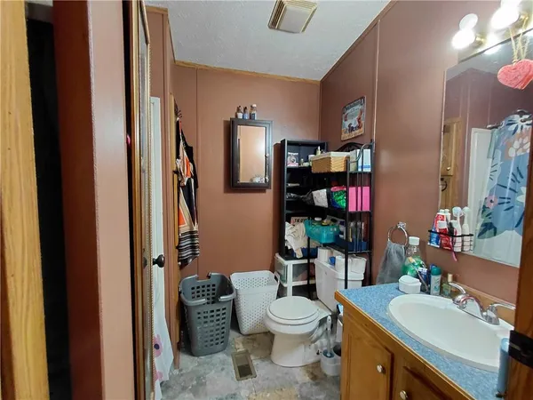 a bathroom with a toilet a sink and a large mirror