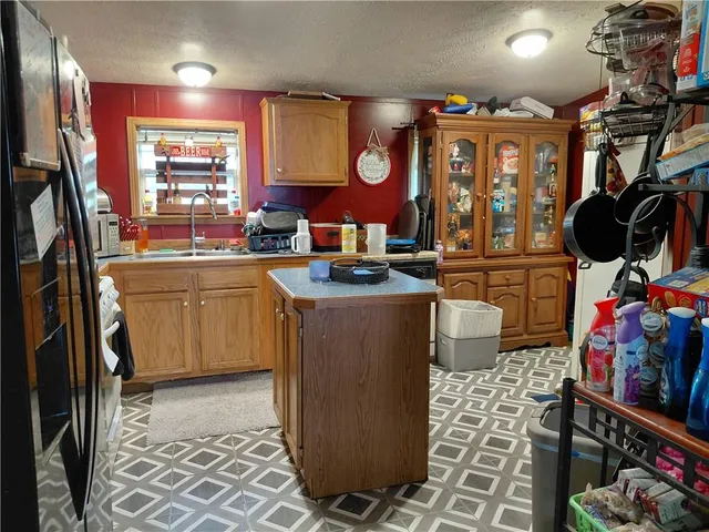 a kitchen with stainless steel appliances granite countertop a sink a stove and a refrigerator